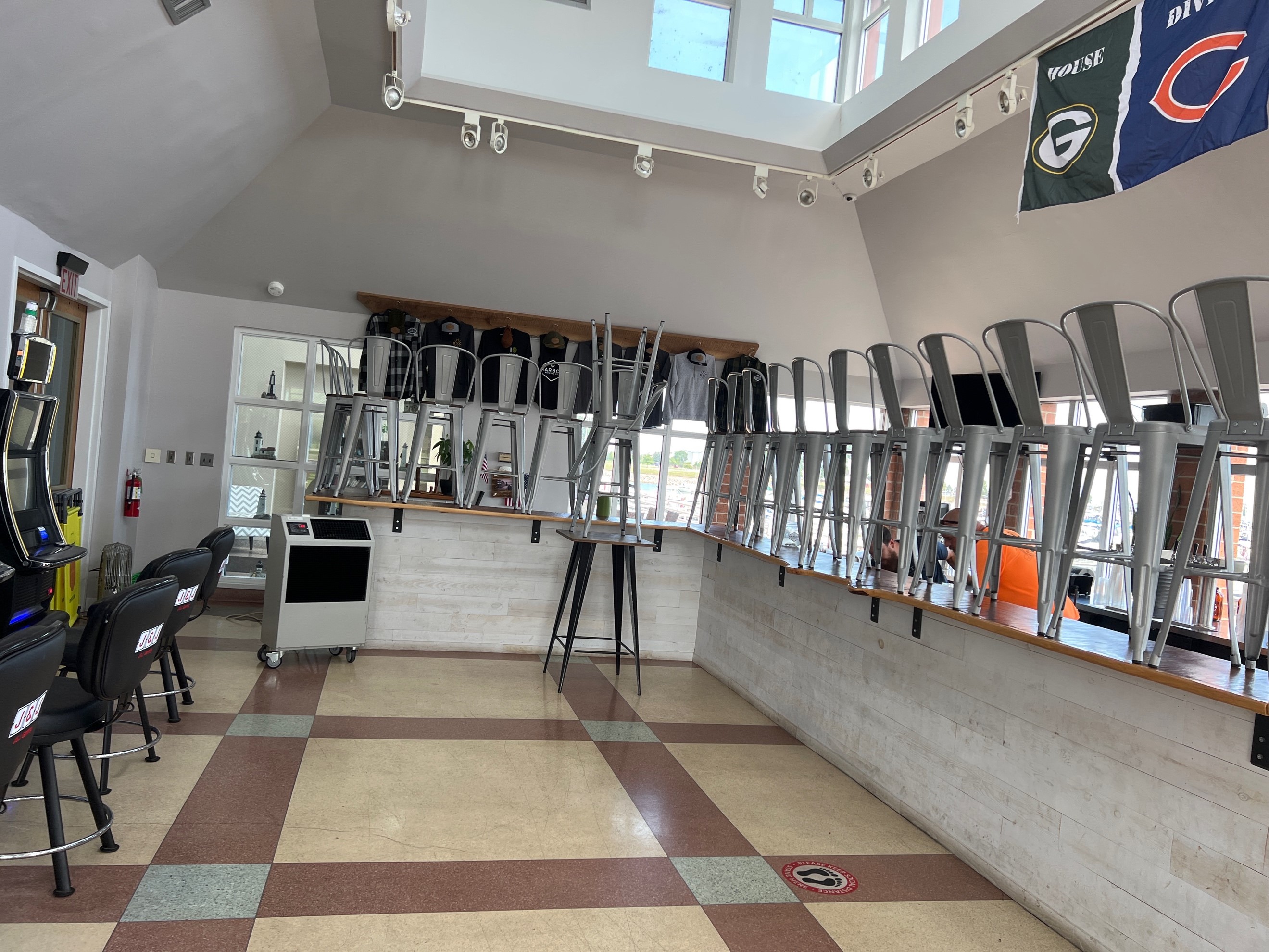 An indoor food area with a bar area being cooled by using rental air coolers.   